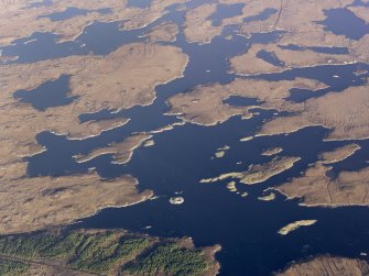 General oblique aerial view of Loch an Duin and the location of the remains of the duns and broch, North Uist, taken from the SSW.