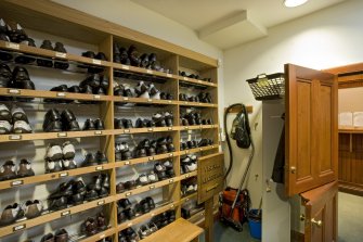 Interior. View of the shoe room adjacent to the men's locker room in Muirfield golf course.