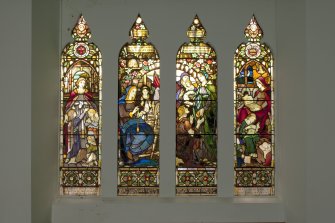 Interior. View of four panelled stained glass window on east wall.