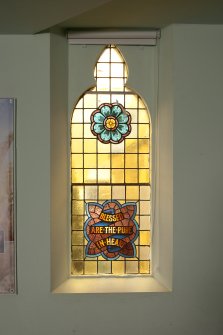 Interior. View of small stained glass window on east wall.