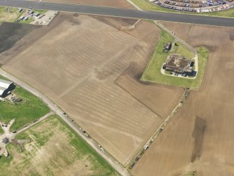 Oblique aerial view of the soilmarks of the rig and furrow at Edzell Airfield, taken from the NE.