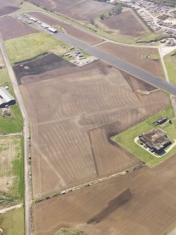 Oblique aerial view of the soilmarks of the rig and furrow at Edzell Airfield, taken from the the N.