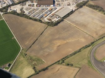 Oblique aerial view of the soilmarks of the rig and furrow at Edzell Airfield, taken from the ENE.