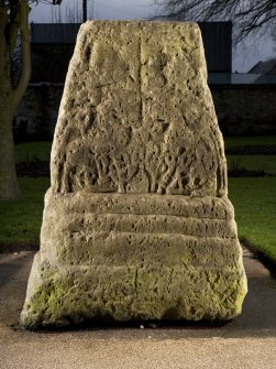 View of carved face of cross base (flash)