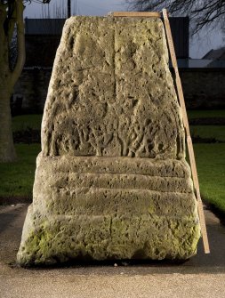 View of carved face of cross base (flash, with scale)