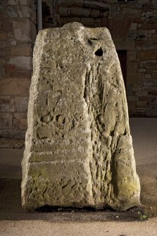 View of carved face of cross base (flash)