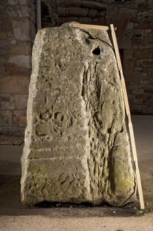 View of carved face of cross base (flash, with scale)