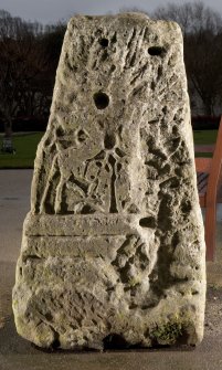 View of carved face of cross base (flash)