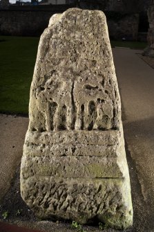 View of carved face of cross base (flash)