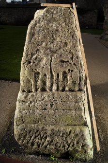 View of carved face of cross base (flash, with scale)