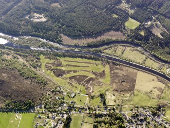 Oblique aerial view of the Caledonian Canal and remains of the military road, field systems and hut circles at Fort Augustus golf course, taken from the ESE.
