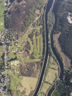 Oblique aerial view of the Caledonian Canal and remains of the military road, field systems and hut circles at Fort Augustus golf course, taken from the ENE.