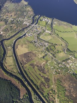 General oblique aerial view of the Caledonian Canal and remains of the military road, field systems and hut circles at Fort Augustus golf course, taken from the SW.