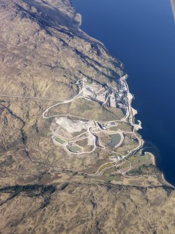 Oblique aerial view of Glensanda quarry, and the remains of the castle, farmstead and field system, taken from the SW.