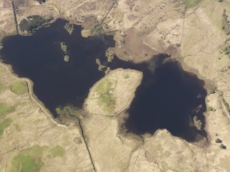 Oblique aerial view of Loch Tromlee and the remains of the buildings, taken from the NE.