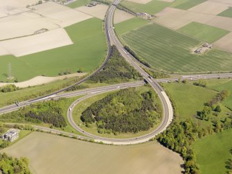 General oblique aerial view of M876 interchange adjacent to Kinnaird House, taken from the SW.