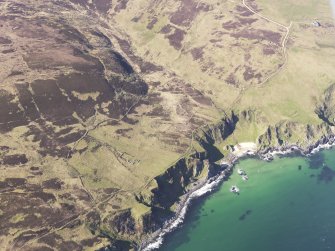 General oblique aerial view of the remains of the farmsteads, head dykes and rig at Leacann Na Coille, Islay, taken from the SSE.