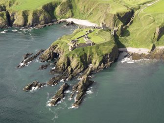 General oblique aerial view of Dunnottar Castle near Stonehaven, taken from the NE.