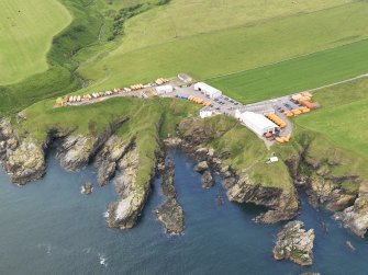 General oblique aerial view of the survival craft inspectorate yard and the site of St Ternan's Chapel and Well, taken from the ESE.