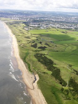 General oblique aerial view of Murcar Golf Course with Aberdeen beyond, taken from the NE.