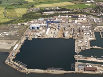 Oblique aerial view of HM Dockyard main basin Rosyth, taken from the SSW.