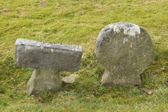 Detail of Round headed and T shaped stones within the burial ground to the south east of church