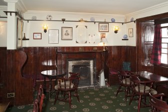 Interior. View within the public bar showing fireplace, bench seating fixtures and timber panelling, taken from west.