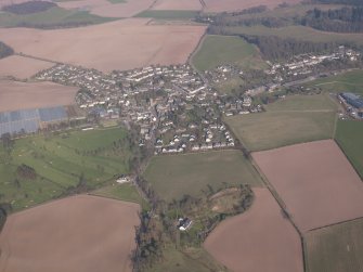 General oblique aerial view of Dunning village with South Lodge, Duncrub House in the foreground, looking N.