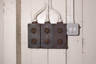 Interior. Cashier's office, detail of triple gang light  switch