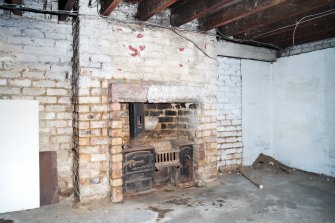 Interior. View of fireplace and range within basement