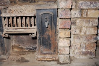 Interior. Detail of range within basement fireplace