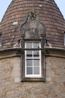 Detail of central dormer window with carved stone pediment at 2nd floor level of south facade
