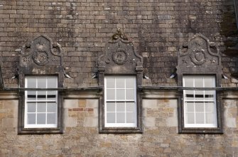 Detail of three dormer windows with carved stone pediments on west facade, Ardkinglas House.