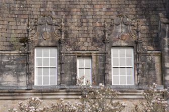 Detail of two dormer windows with carved stone pediments on west facade