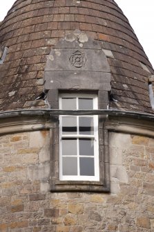 Detail of west dormer window with carved stone pediment at 2nd floor level of south facade