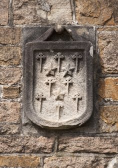 Detail of heraldic shield to left of east entrance