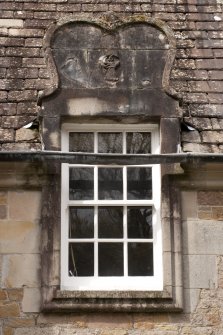 Detail of south dormer window with carved stone pediment at 1st floor level of east facade