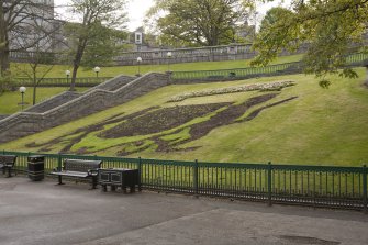 View looking up to top terrace showing heraldic crest flower bed, taken from the south east.