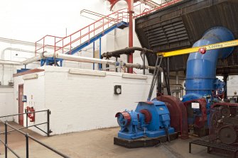 Interior. Turbine house, view of turbine, lade and steps to upper level