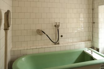 Interior. 1st floor, central bathroom, view showing bath, shower attachment and scales
