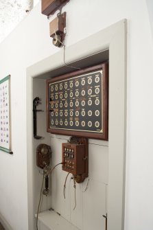 Interior. 1st floor, service corridor, view of bellboard and telephone