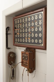 Interior. 1st floor, service corridor, detail of bellboard and telephone