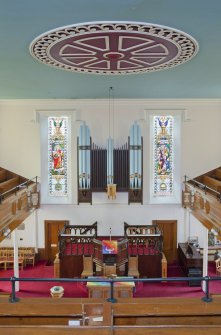 General view  looking across the upper level of the sanctuary, including central ceiling rose and organ pipes, taken from the rear gallery.