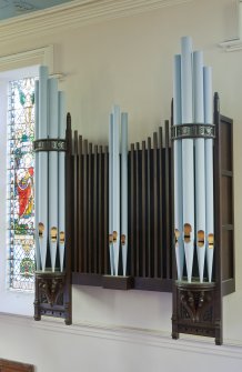 View from side gallery looking onto organ pipes mounted on north west wall of sanctuary.