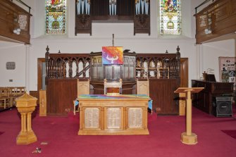 View of chancel area with pulpit and furniture.