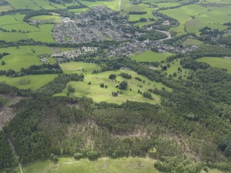 General oblique aerial view of Comrie centred on the golf course, taken from the NNE.