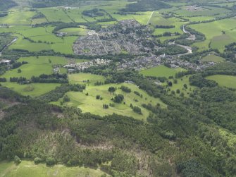 General oblique aerial view of Comrie centred on the golf course, taken from the N.