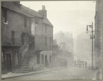 Photograph showing Candlemaker Row, Edinburgh.
Titled: 'Candlemaker Row - West side, looking north, showing old Houses on Churchyard wall. (now demolished.). 1890. G G.Mitchell'.
Edinburgh Photographic Society Survey of Edinburgh and District, Ward XIV George Square