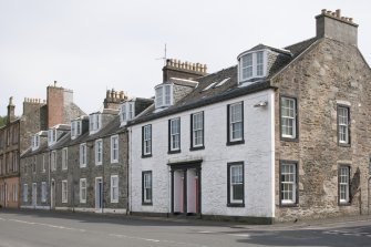 General view from NW showing terraced houses at 59, 60, 61, 62, 63, 64 and 65 Marine Road, Port Bannatyne, Bute