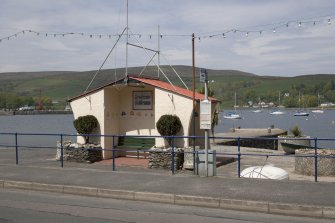 View from S showing bus shelter and Quay, Marine Road, Port Bannatyne, Bute
